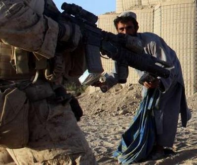 An Afghani clears away rubble, but not fast enough.