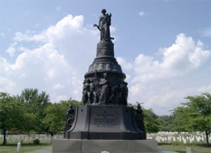 Peaked headstones that mark the graves of Confederate soldiers surround the Confederate Monument in Jackson Circle. At the top of the monument is the solemn figure of a woman representing the South extends a laurel wreath toward her fallen sons. Peaked headstones that mark the graves of Confederate soldiers surround the Confederate Monument in Jackson Circle. At the top of the monument is the solemn figure of a woman representing the South extends a laurel wreath toward her fallen sons.